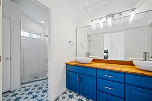 Bathroom with vanity and a tile shower