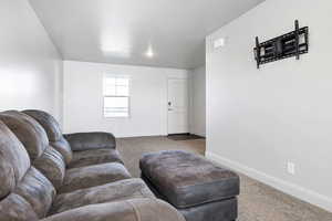 Living room featuring a textured ceiling and carpet flooring