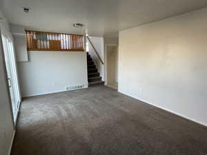 Unfurnished living room featuring carpet flooring