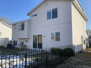 Snow covered property featuring central AC unit