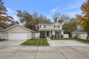 View of front property with a garage and a front lawn