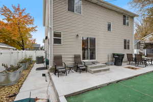 Rear view of house featuring central AC and a patio