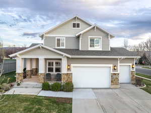 Craftsman-style home featuring a garage and a porch