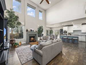 Living room featuring ceiling fan and dark hardwood / wood-style flooring