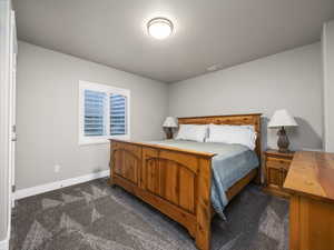 Carpeted bedroom with a textured ceiling