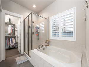 Bathroom with separate shower and tub and tile patterned flooring