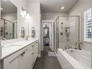 Bathroom with vanity, separate shower and tub, and tile patterned floors