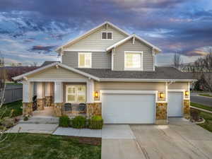 Craftsman-style home featuring a garage and covered porch