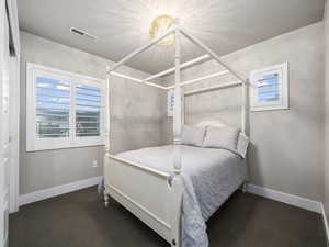 Carpeted bedroom with a textured ceiling