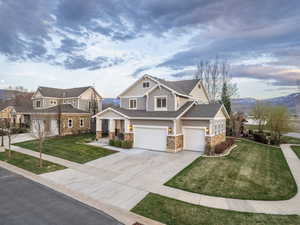 Craftsman-style home with a mountain view, a garage, and a front yard