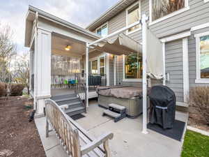 View of patio / terrace with a hot tub and grilling area