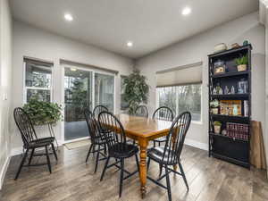 Dining room with dark hardwood / wood-style floors