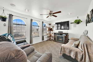 Living room with ceiling fan and carpet flooring