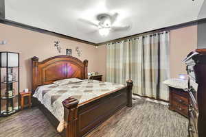 Bedroom featuring dark carpet and ceiling fan