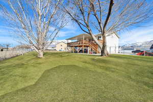 View of yard with a deck with mountain view