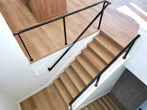 Staircase featuring hardwood / wood-style floors