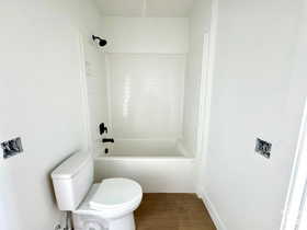 Bathroom featuring shower / bathing tub combination and toilet