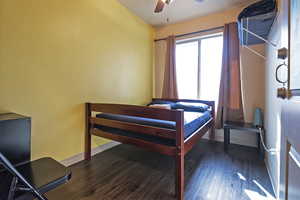 Bedroom with dark wood-type flooring and ceiling fan
