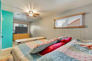 Bedroom with multiple windows and ceiling fan