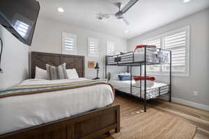 Bedroom with hardwood / wood-style floors and ceiling fan