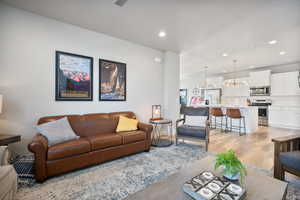 Living room featuring a chandelier and light wood-type flooring