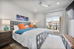 Bedroom with access to exterior, light hardwood / wood-style floors, and ceiling fan