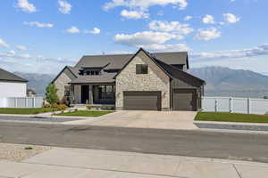 View of front of home with a garage and a mountain view