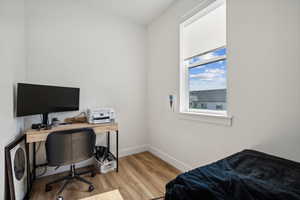 Bedroom with light hardwood / wood-style flooring