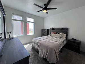 Carpeted bedroom with ceiling fan