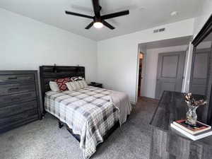 Bedroom featuring dark colored carpet and ceiling fan