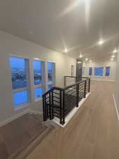 Corridor with hardwood / wood-style flooring