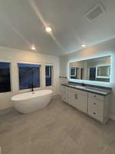 Bathroom featuring vanity and a bathtub