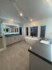 Bathroom featuring vanity and plus walk in shower