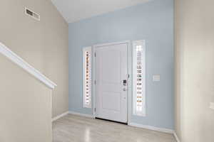 Foyer entrance with light hardwood / wood-style floors