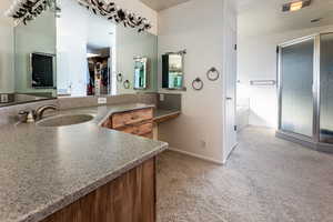 Bathroom featuring vanity and shower with separate bathtub