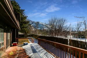 Snow covered deck with a mountain view