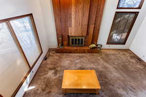 Unfurnished living room featuring dark carpet