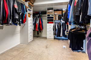 Spacious closet with light colored carpet