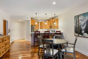 Dining room with dark wood-type flooring