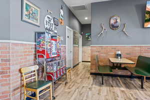 Dining area featuring indoor bar and light hardwood / wood-style flooring