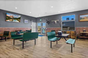 Interior space with brick wall and light wood-type flooring