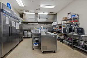 Kitchen featuring a kitchen island and stainless steel fridge