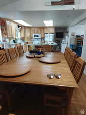 Dining space with dark hardwood / wood-style floors