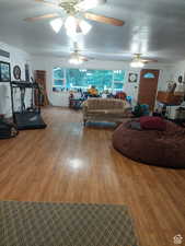 Living room featuring hardwood / wood-style flooring, a textured ceiling, and a wealth of natural light