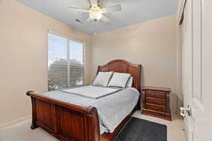 Third bedroom featuring ceiling fan, a closet, and carpet