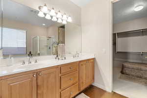 Primary ensuite bathroom with an enclosed shower, a separate bathtub, and a double vanity