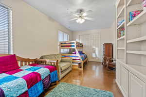 Fourth bedroom featuring a closet and ceiling fan