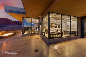 Patio terrace at dusk featuring a mountain view and a fire pit