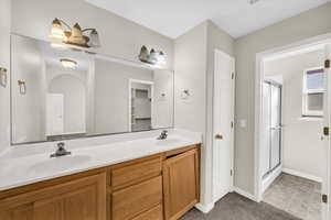 Bathroom with a shower with door and vanity