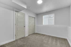 Unfurnished bedroom featuring carpet floors and a closet